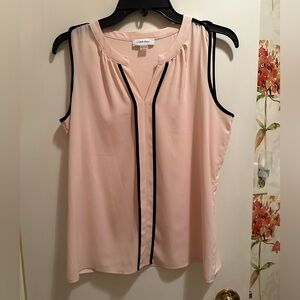 Light pink and black sleeveless blouse.